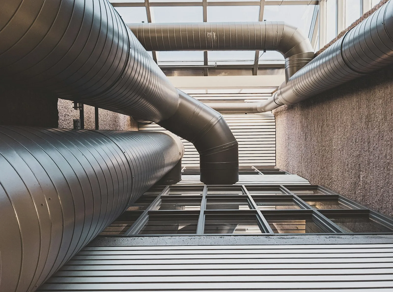 Steel ventilation ducts running between two buildings